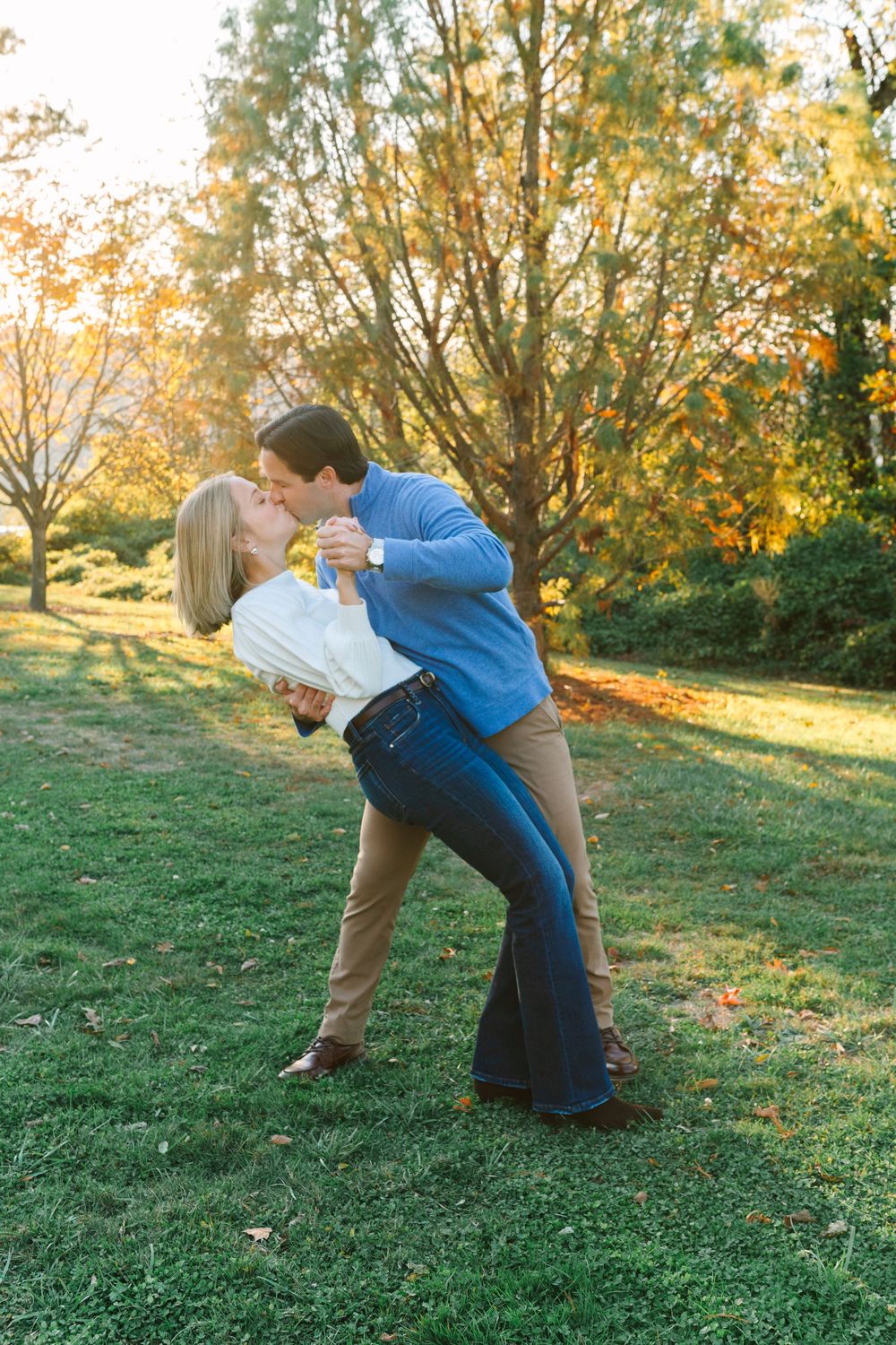 Playful dip pose sequence on grassy hill during golden hour.