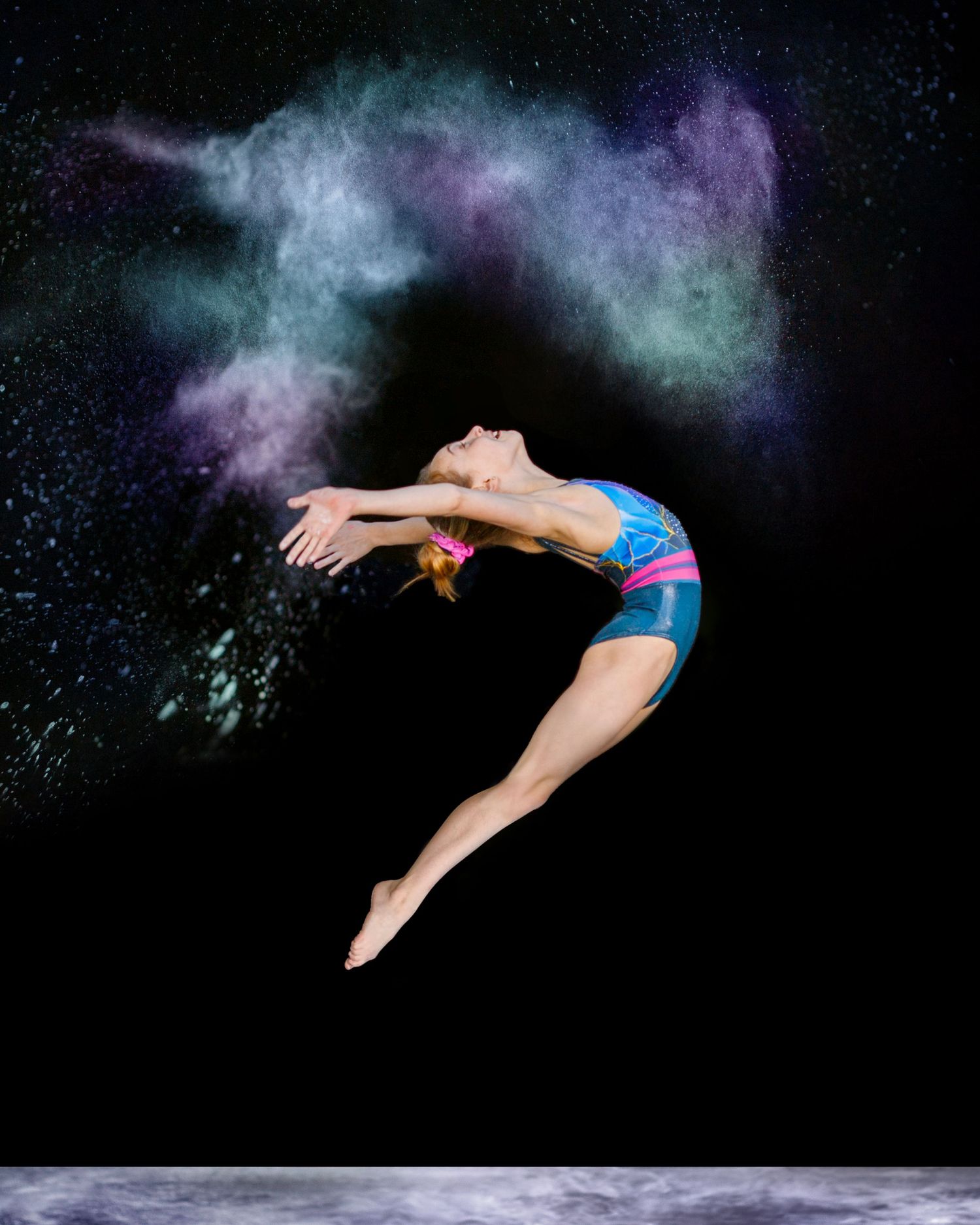 dancer flying in mid air during a fun and magical chalk powder photo session in Bergen County, nj