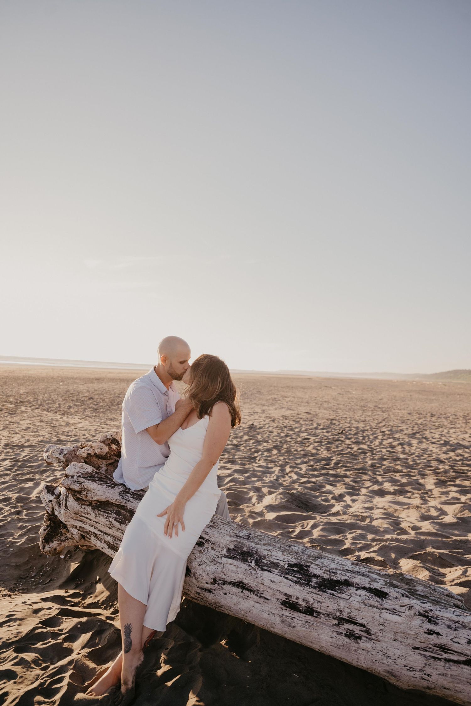 Intimate lifestyle portrait of a joyful couple laying down and laughing together.