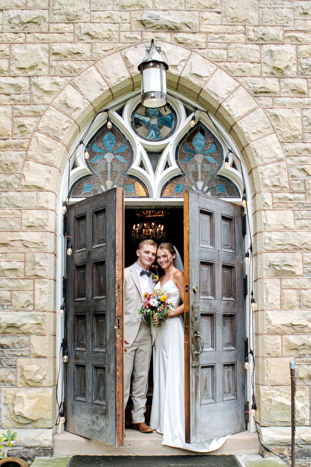 Beautiful Buffalo bride and groom pose in front of the church in Lewiston, N.Y.