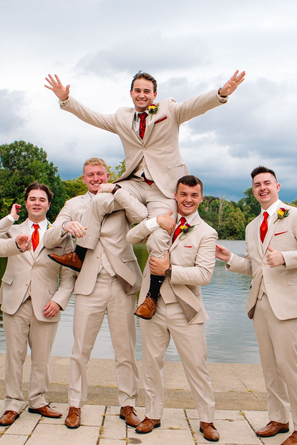 Groomsmen and Groom pose for bridal portraits at Delaware Park at Hoyt Lake in Delaware Park during this September Wedding.