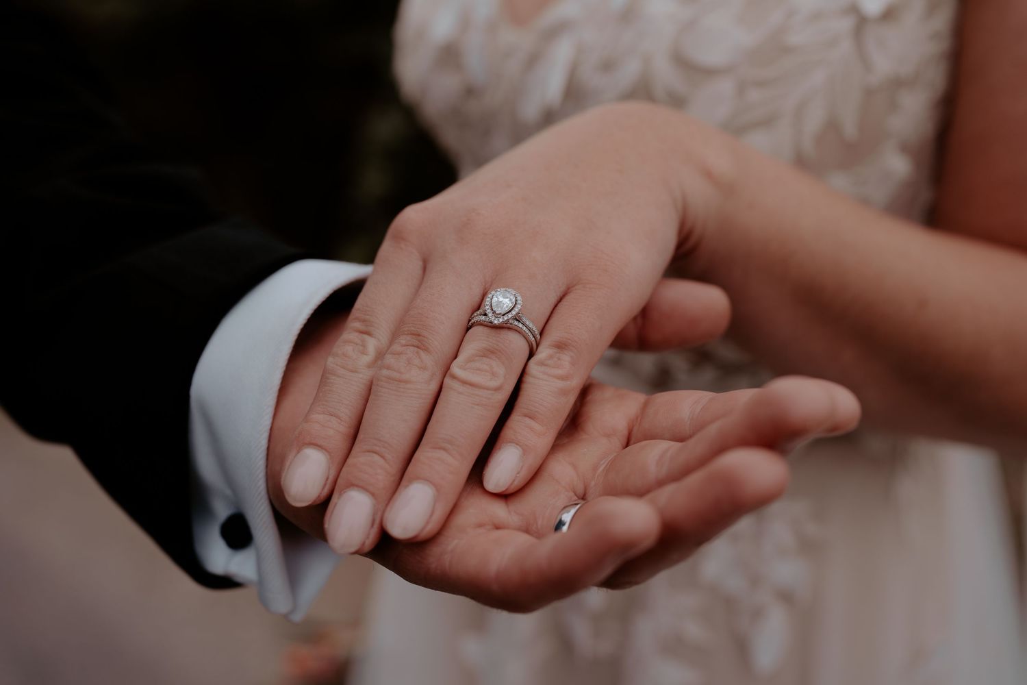 Intimate wedding portrait captured during sunset in moody, romantic lighting.