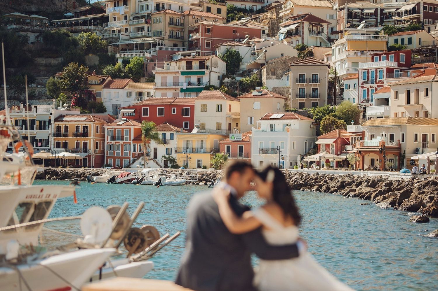 Romantic sunset scene with street lamp and coastal buildings in Mediterranean town.