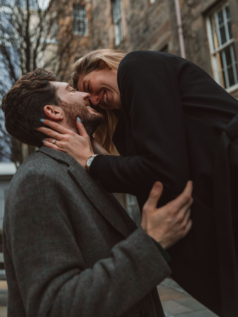 Romantic winter embrace captured in a series of intimate moments against urban backdrop.