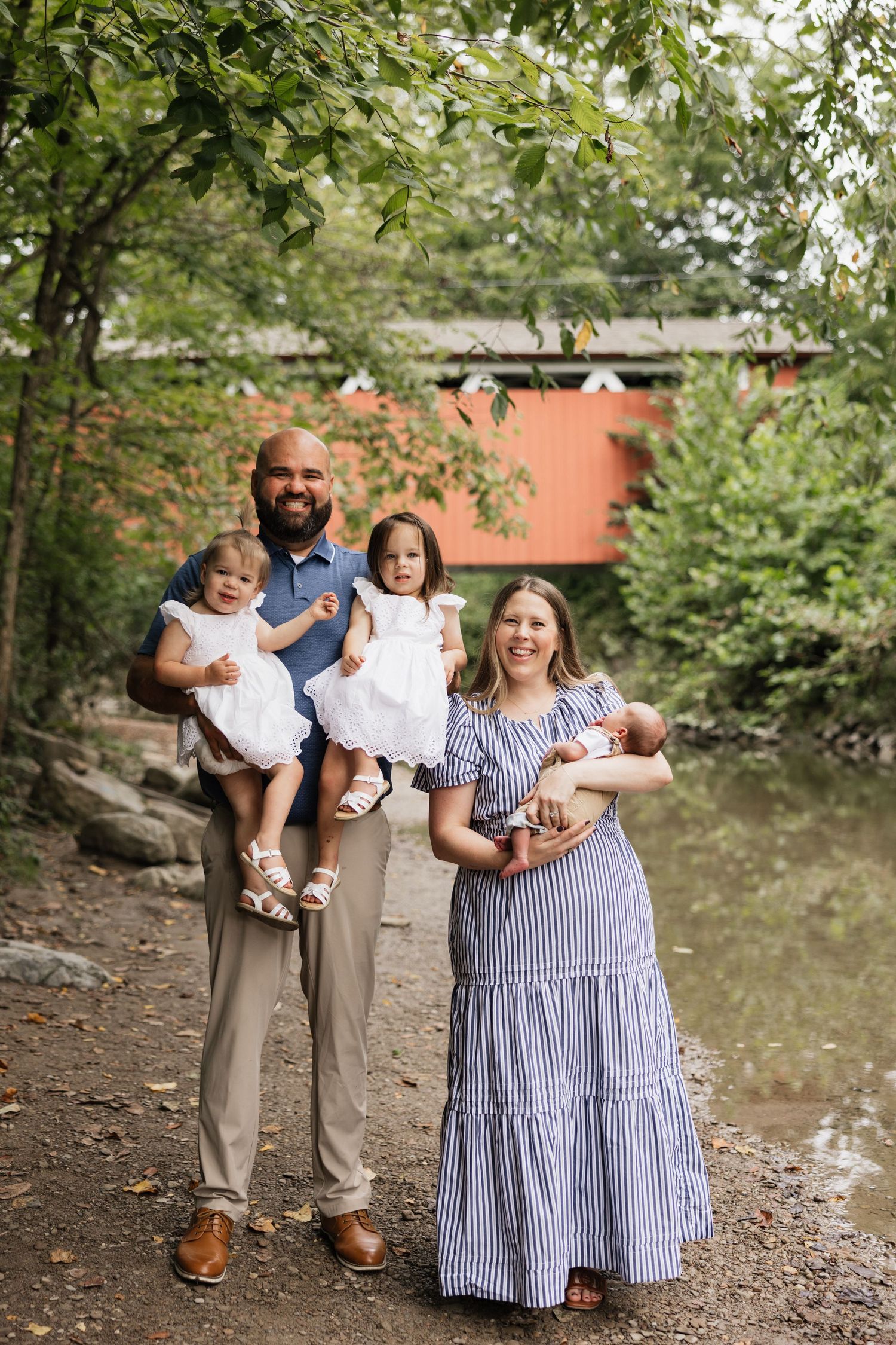 An outdoor family newborn session by the water in the Cuyahoga Valley National Park with toddlers.