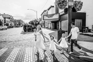 A series of black and white photographs showing a wedding couple celebrating in urban street settings.