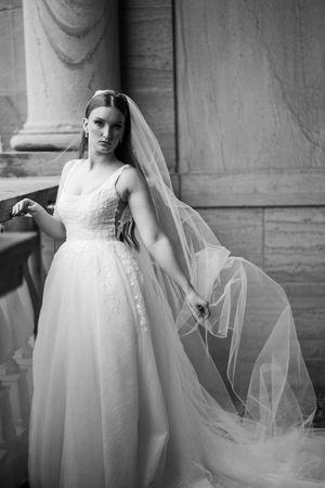 Black and white artistic wedding dress photos showing flowing tulle fabric and elegant bridal gown details.