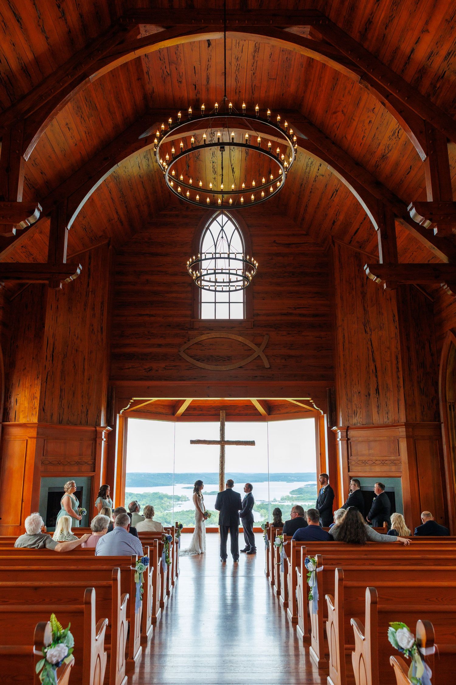 Interior of a wooden chapel with vaulted ceiling and chandelier, overlooking Table Rock Lake at Top of the Rock at Big Cedar Lodge.