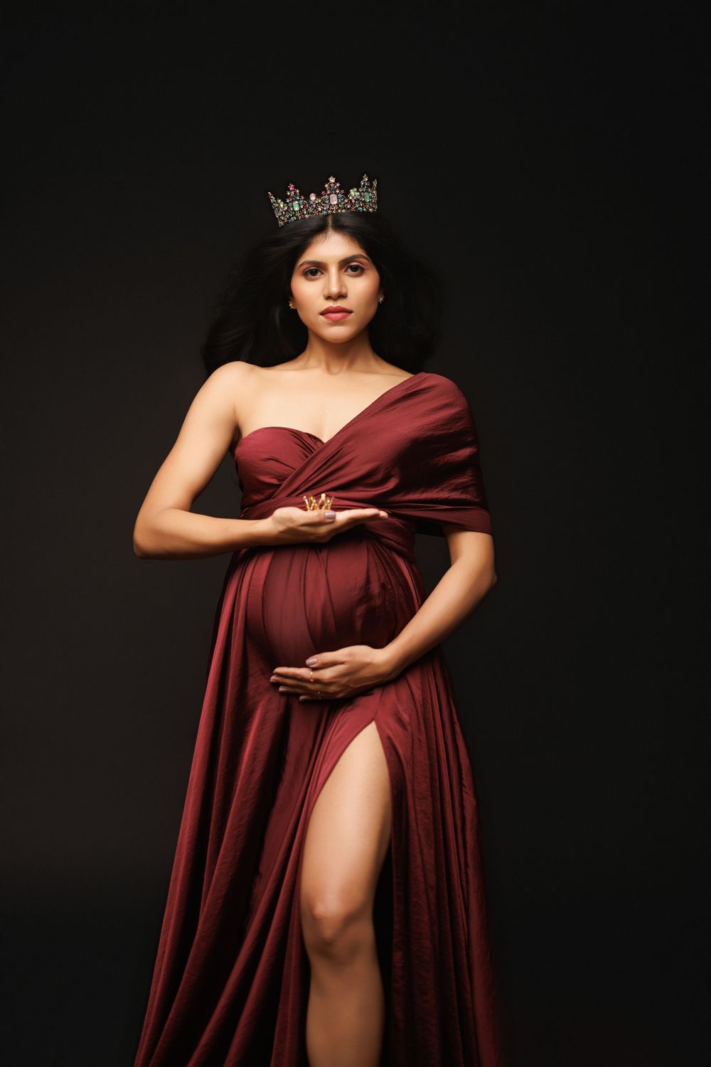 Artistic portrait series showing figure in burgundy draped fabric posed against dark background.