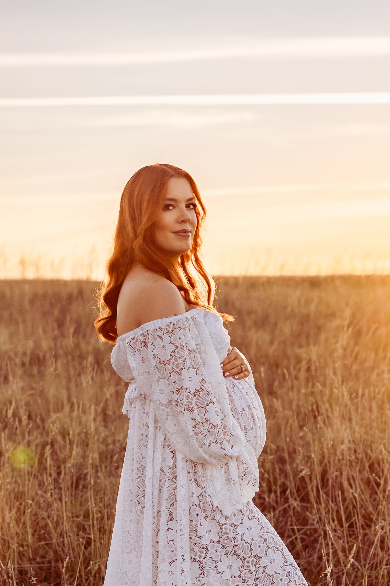 Maternity portraits in a stunning flowing red gown in Wellington Maternity Studio