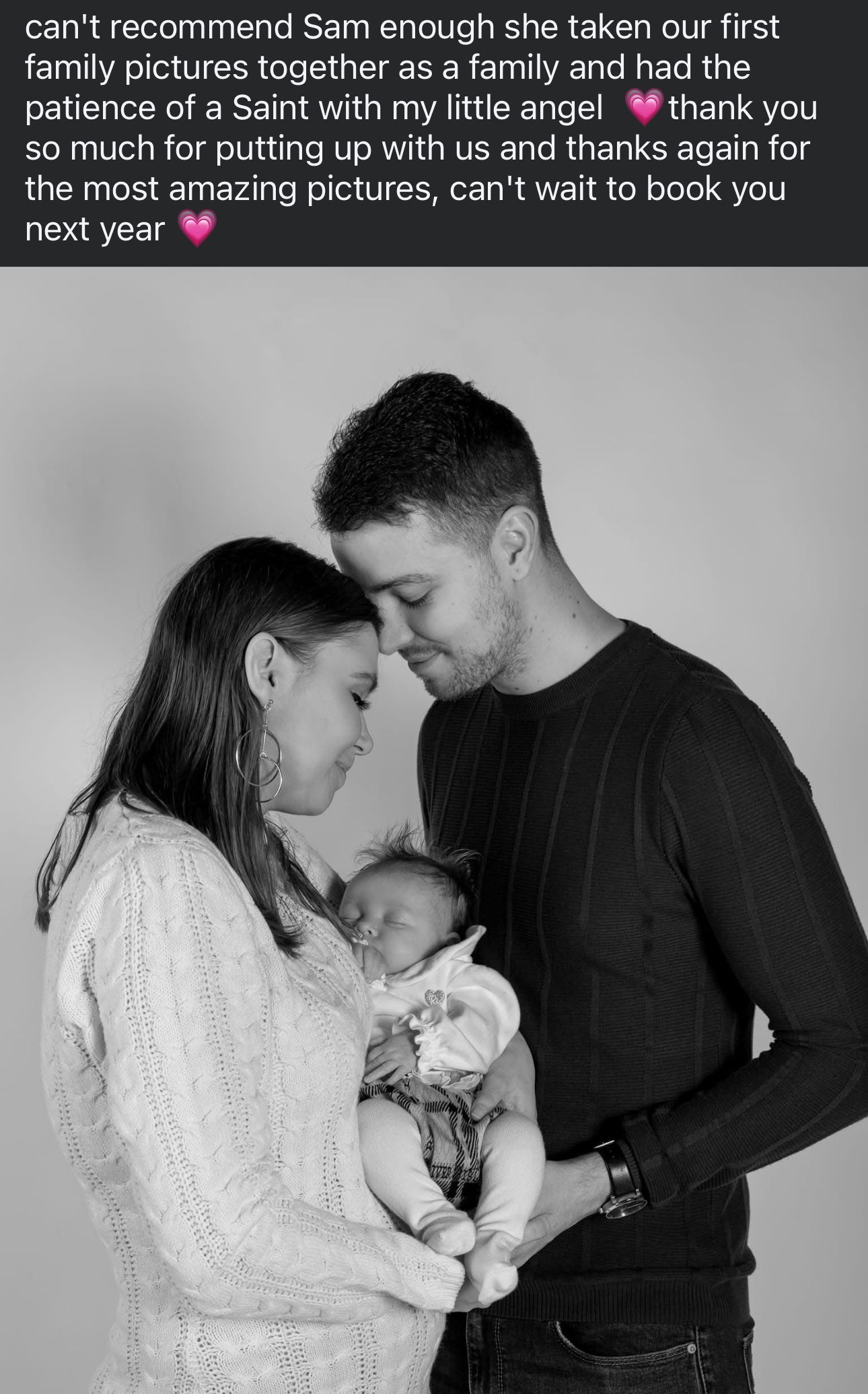 A tender black and white family portrait showing a newborn baby being held by parents.