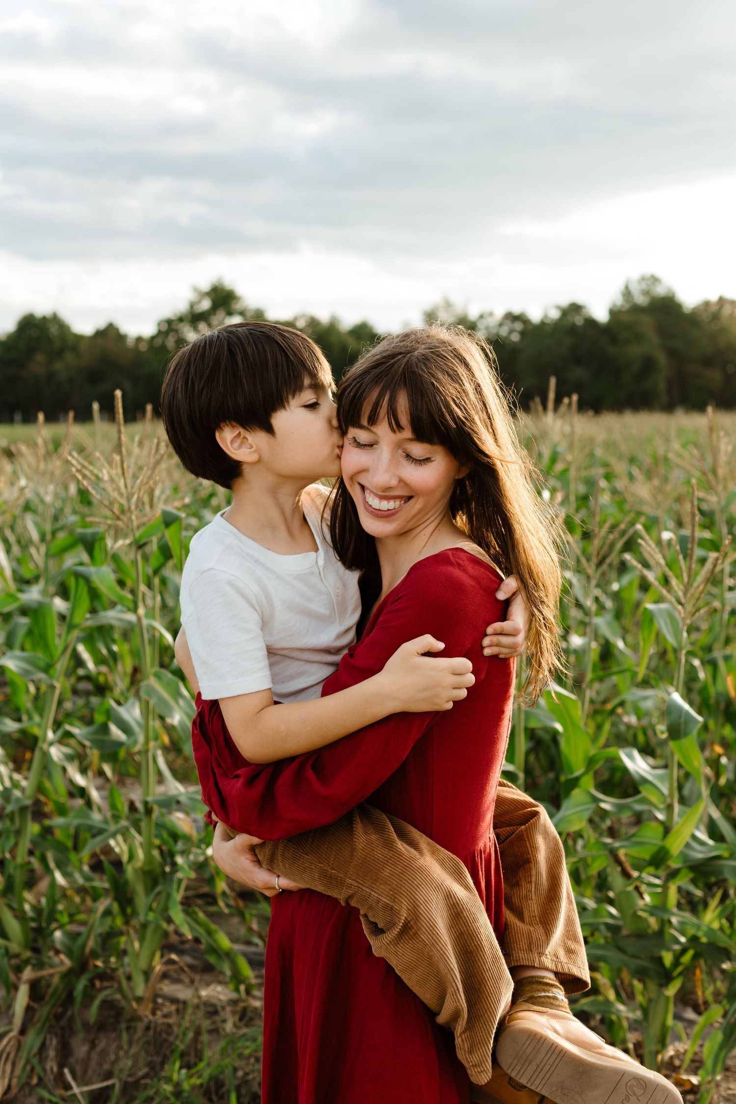 child hugs mother, fall mini session in a corn field, NJ family photographer