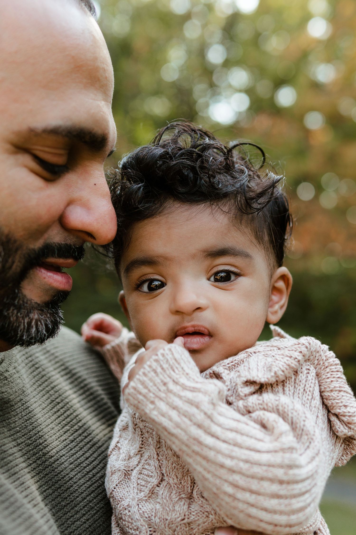 Close-up portrait of a loving parent and baby in cozy sweaters during fall mini session in Cherry Hill, NJ.