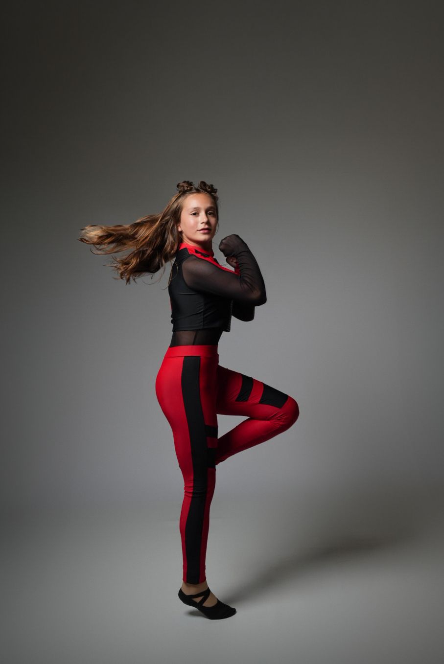 Young woman in prom dress dancing