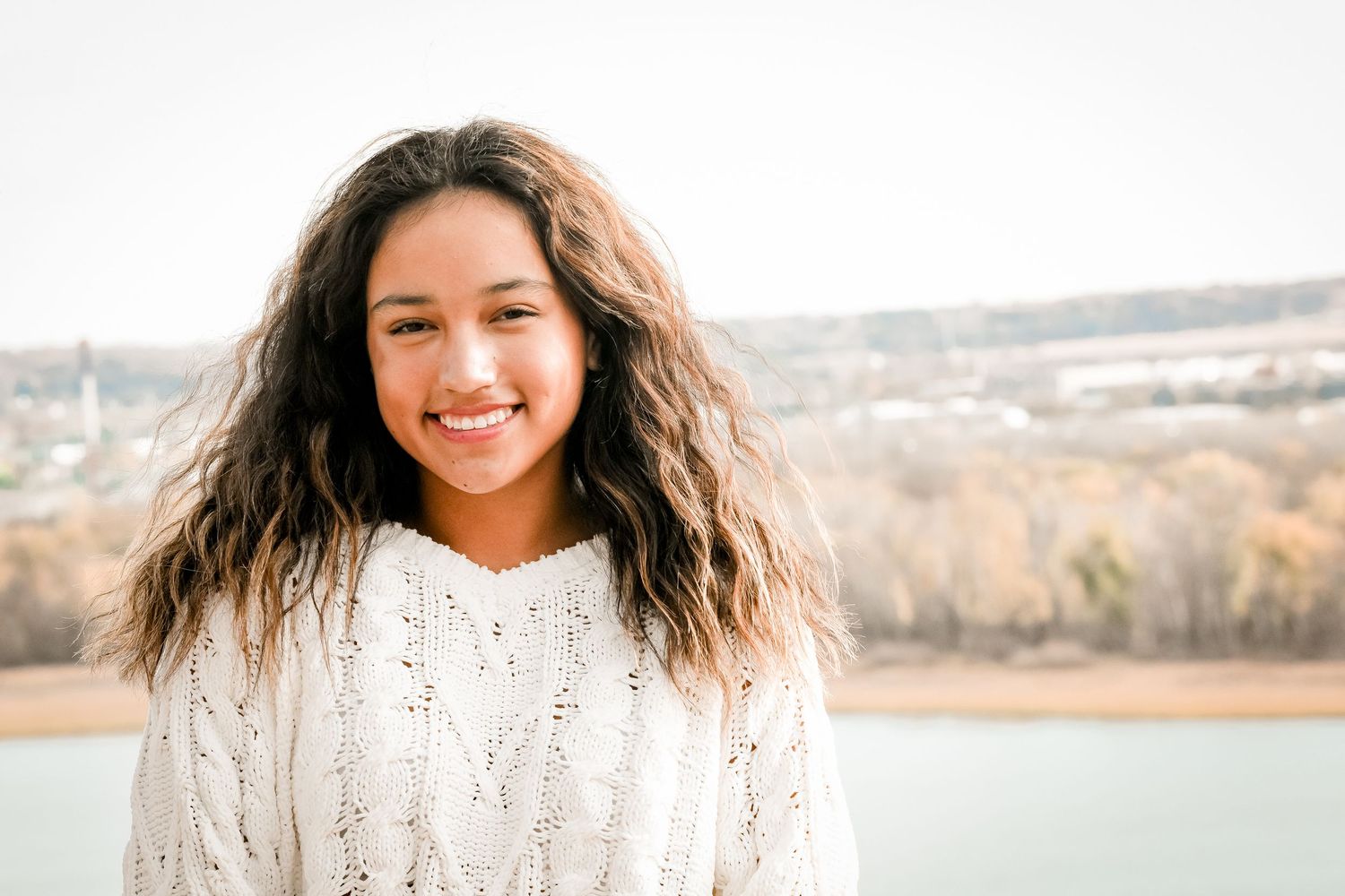 Natural sunlit portrait series in a cream sweater by the water.