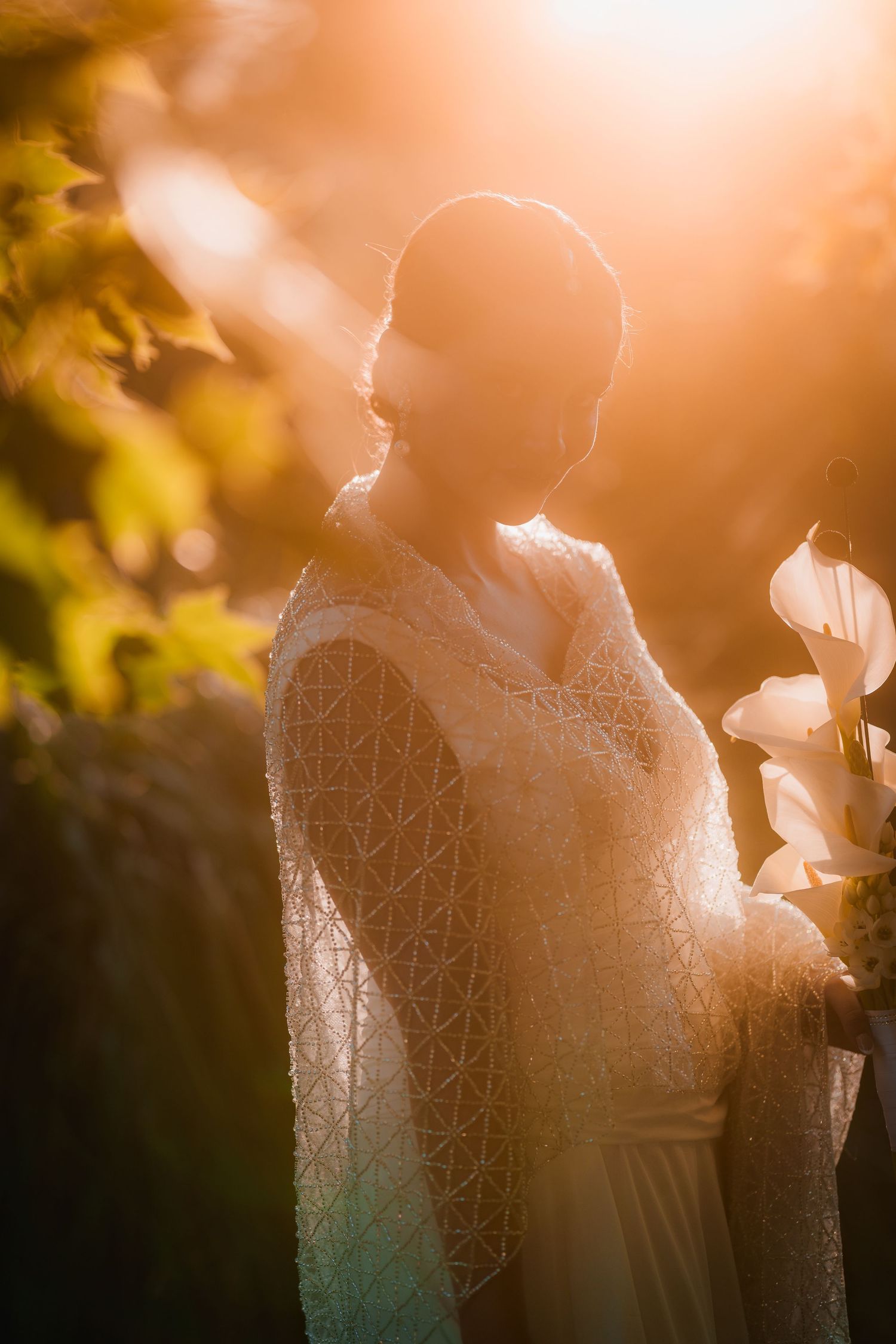 Newlyweds exit church amid colorful confetti shower surrounded by joyful guests.