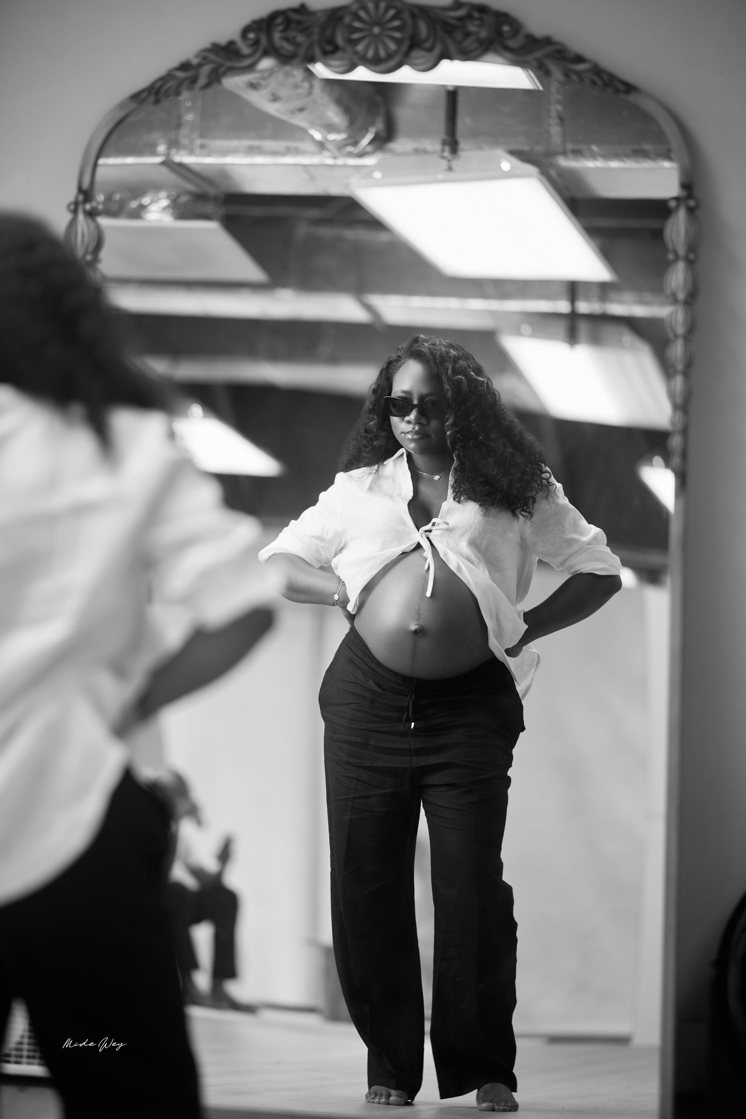 A black and white photo sequence shows a person in dark clothing practicing dance movements in a studio.