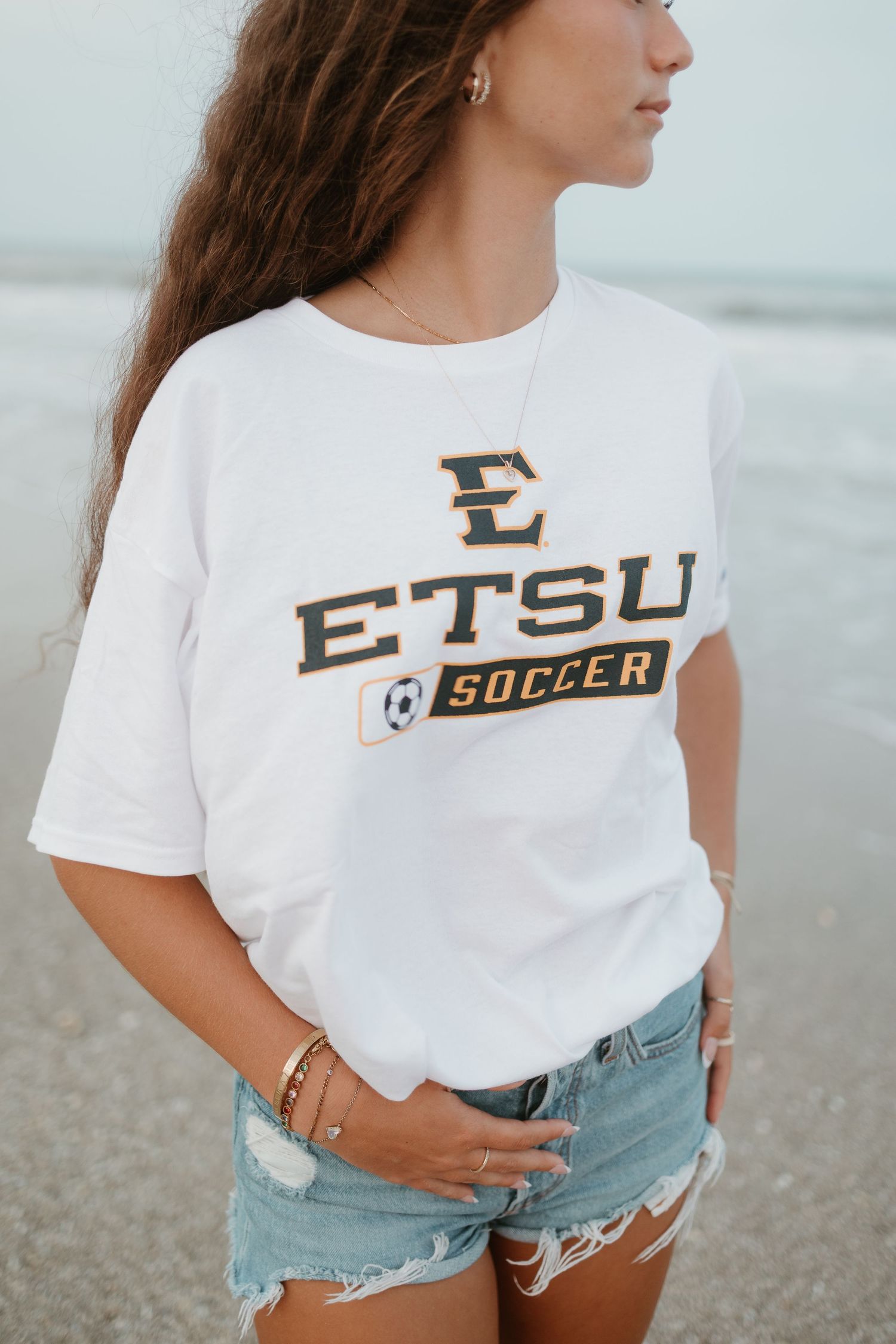 Close-up shots of ETSU Soccer t-shirt design on white fabric.