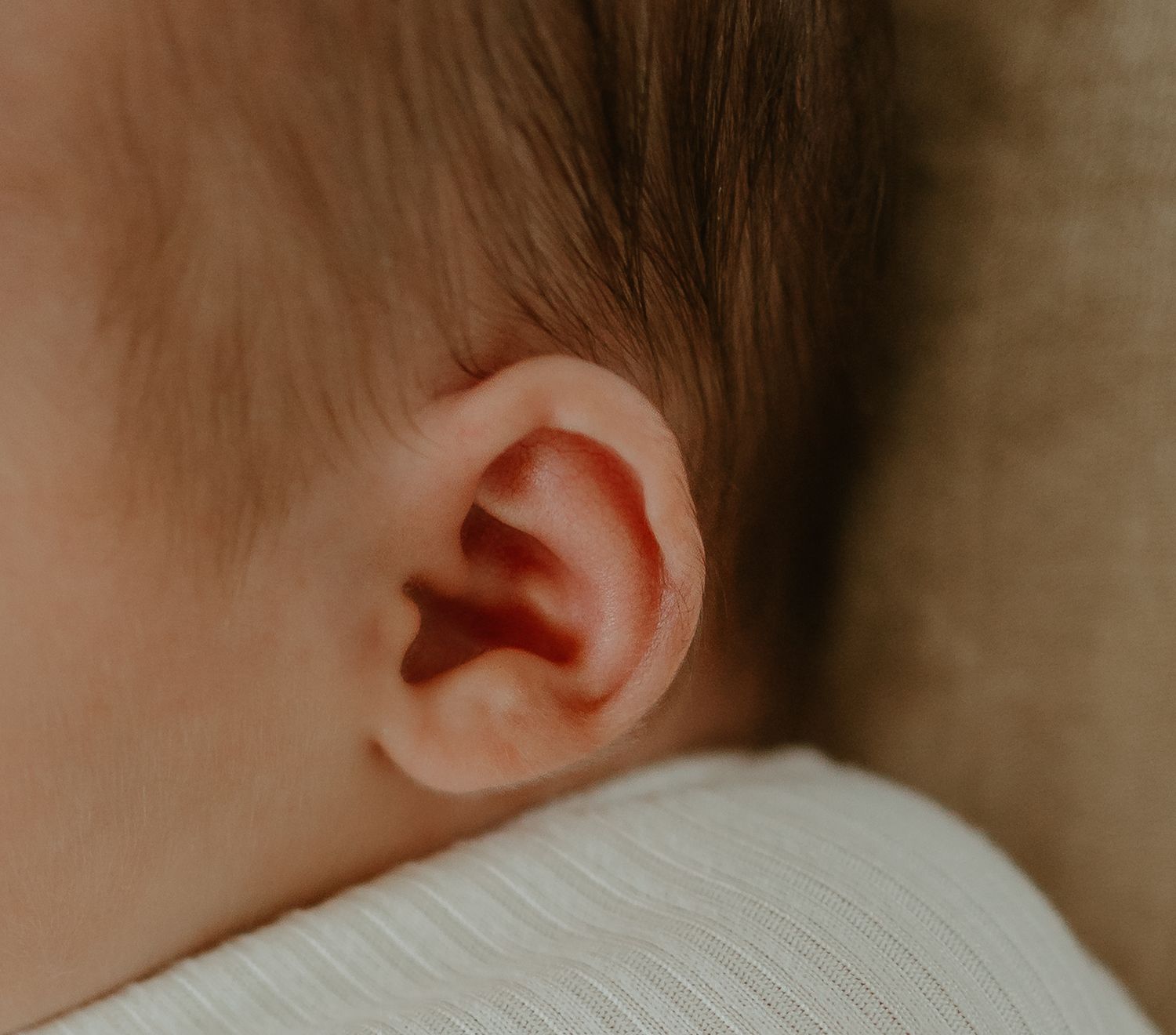 Close up macro shot of a baby's ear and soft skin.