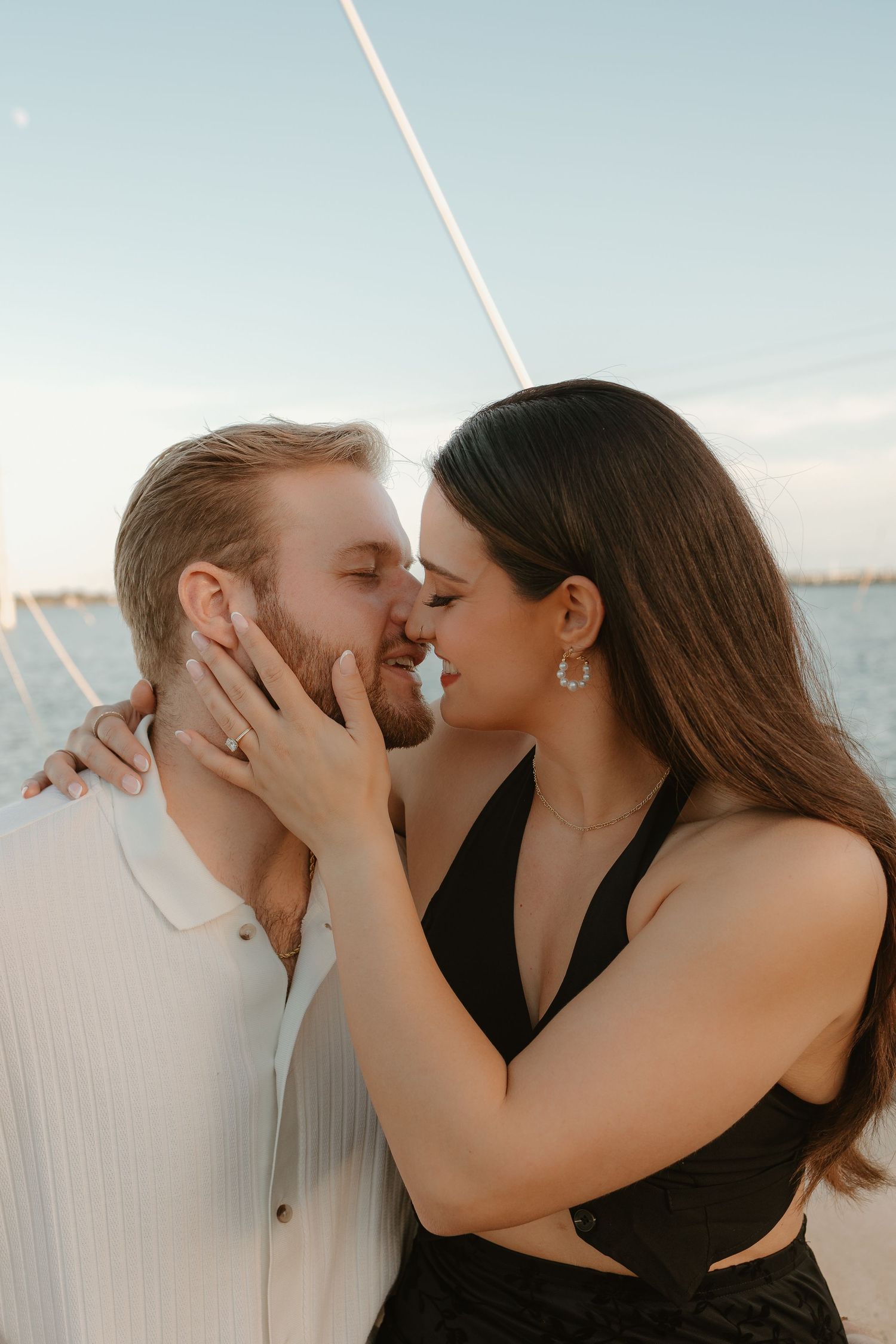 Intimate couple sharing romantic moment at beach during sunset.