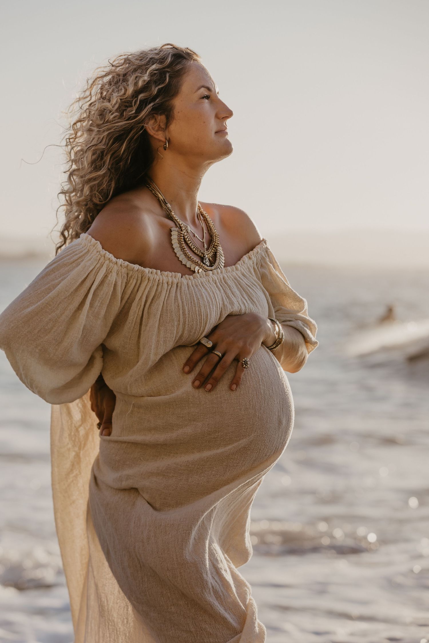 Pregnant enjoying a joyful moment by the ocean before her Byron Bay birth