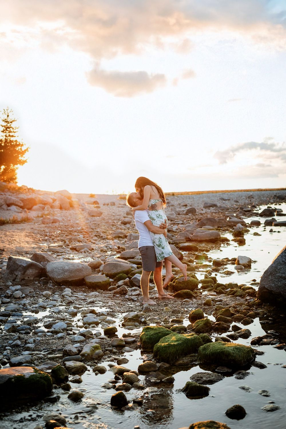 A romantic photoshoot at sunset among tide pools and rocky shoreline.