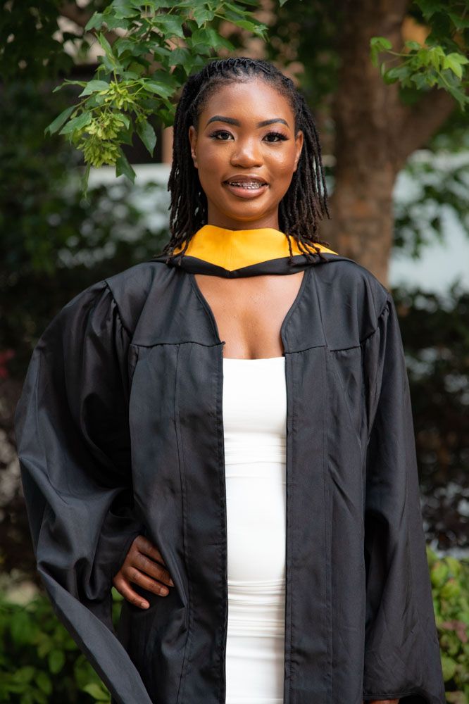 Academic graduation photos in black cap and gown with gold stole outdoors.
