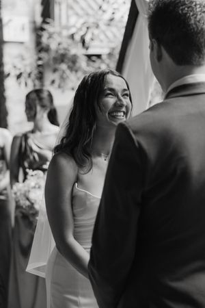 A series of black and white photos showing a couple sharing joyful moments during their wedding reception.