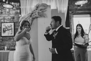 Wedding couple sharing emotional moment during reception speeches.