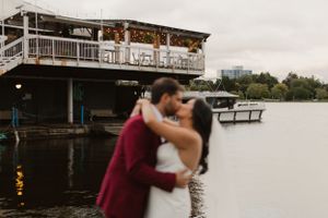 Romantic waterfront wedding moment at rustic dock venue.