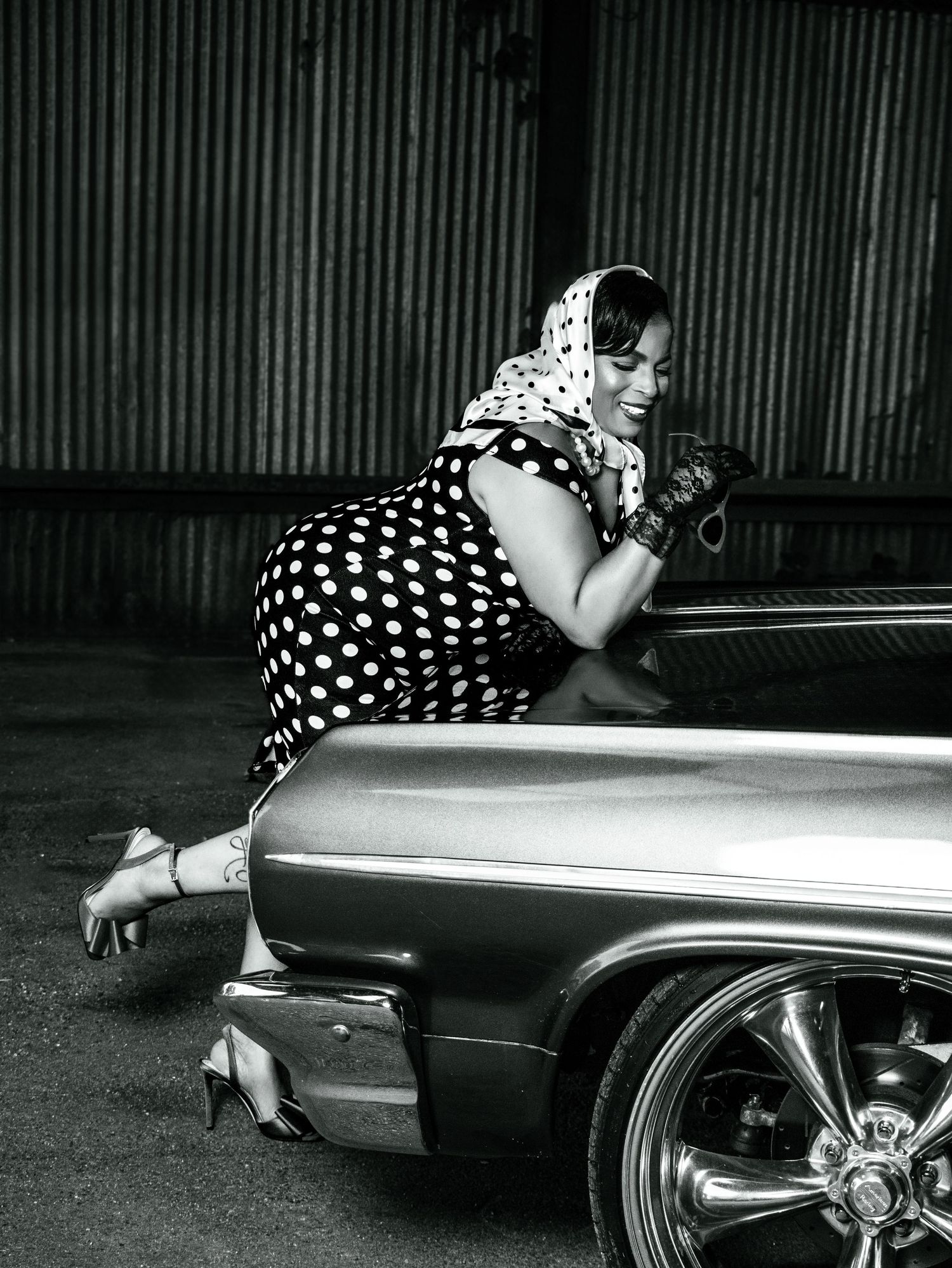 A vintage black and white photo series shows someone in polka dots leaning over the side of a classic car.