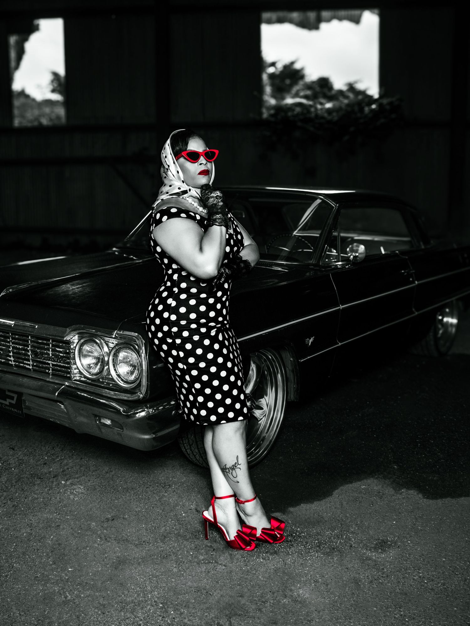 Black and white photo series featuring a polka dot dress and red shoes against a vintage car background.