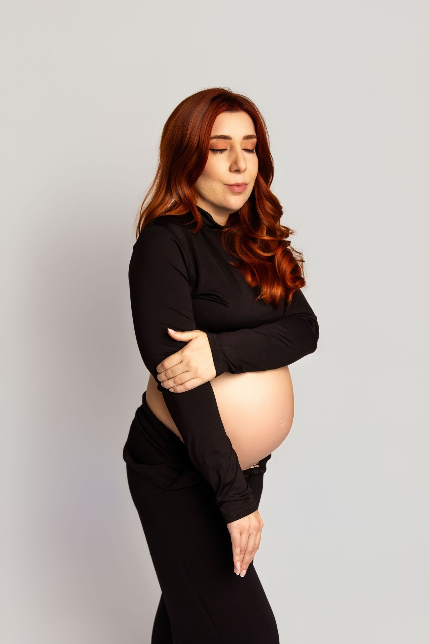 Artistic maternity portraits showing tender moments and baby bump.