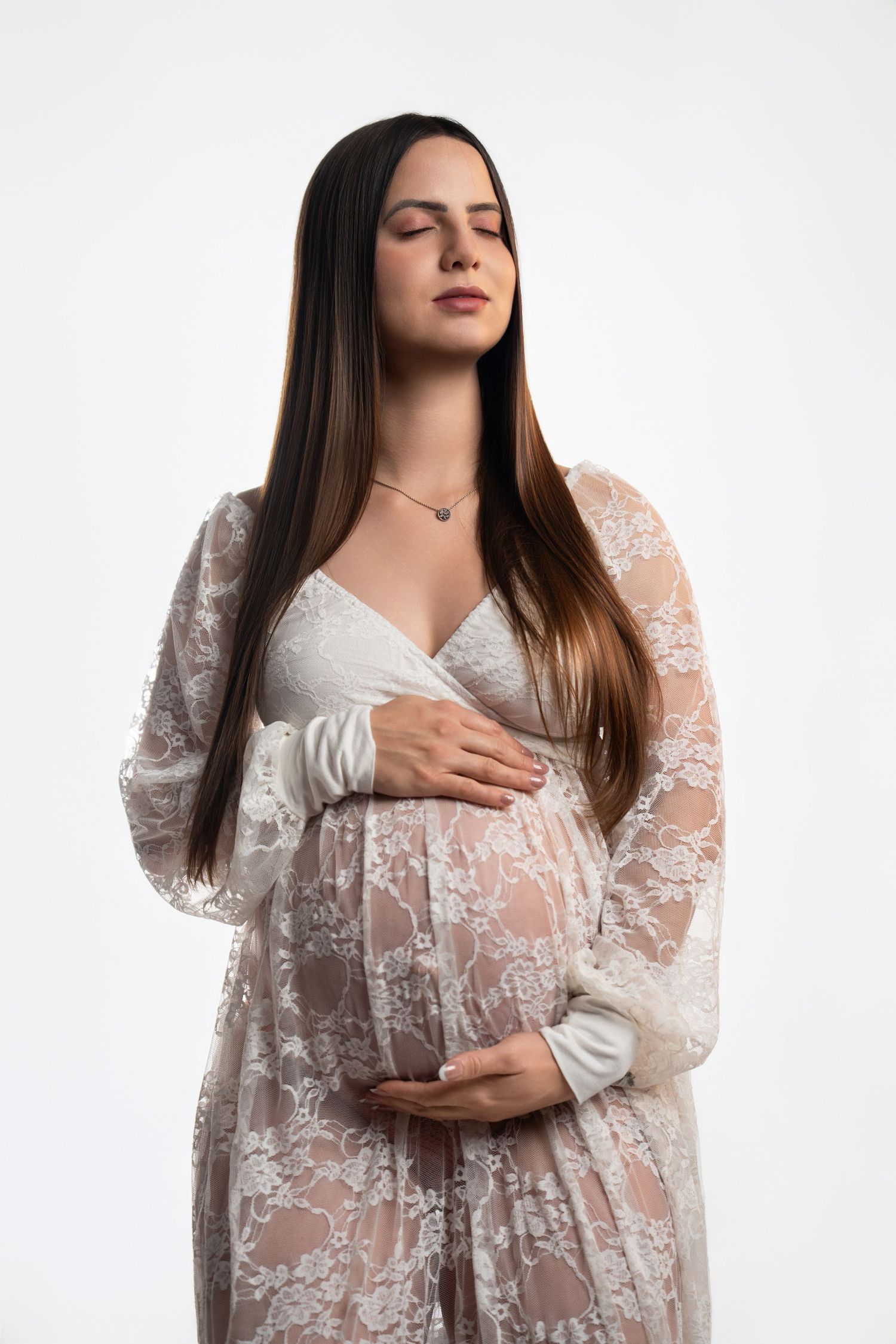 Ethereal maternity portraits in delicate white lace dress.