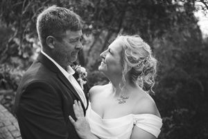 Black and white wedding portraits showing intimate moments between newlyweds.