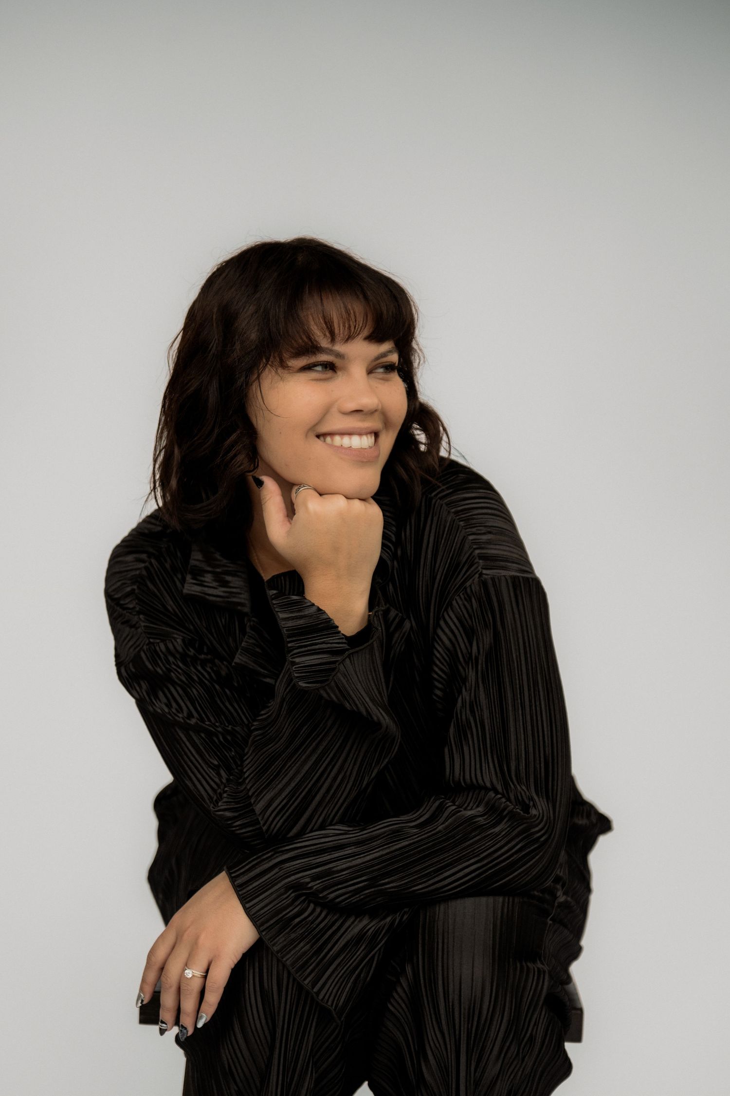 A photographer smiling holding a camera.