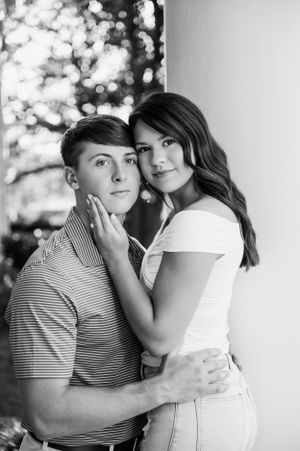 A series of intimate black and white portraits showing a couple sharing playful moments together.