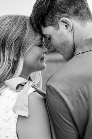 A series of intimate black and white close-up shots showing tender moments between a couple.