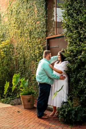 A series of romantic poses captured on a brick patio surrounded by greenery.