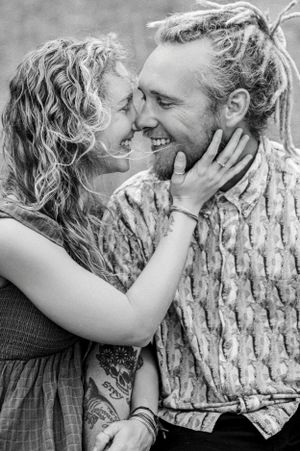 A series of black and white photos showing tender moments between a couple against a tree trunk.