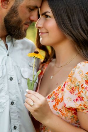 Close-up shots of couple sharing intimate moments while holding flowers.