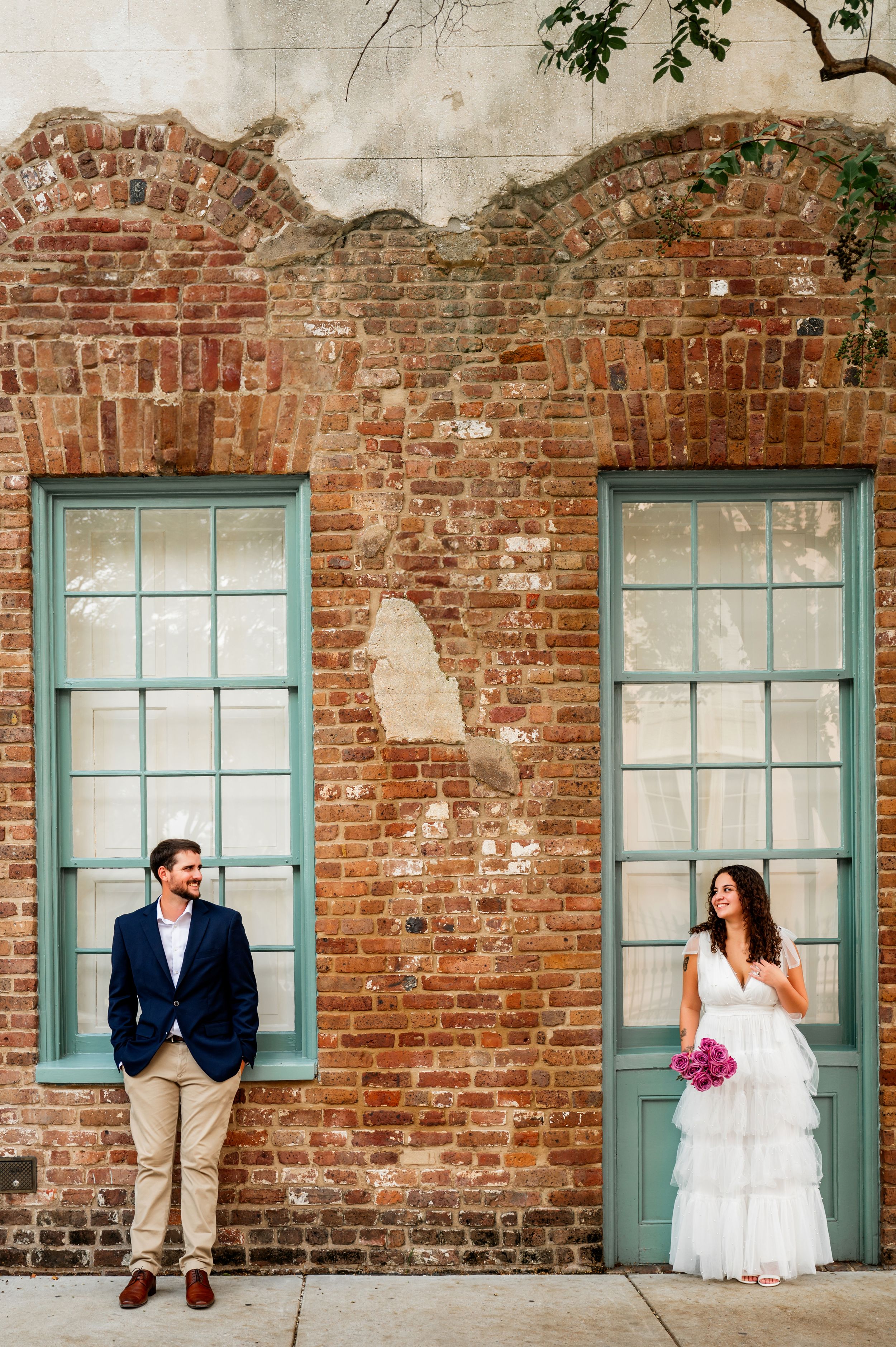 Wedding photo sequence against rustic brick wall with teal windows and pink bouquet.