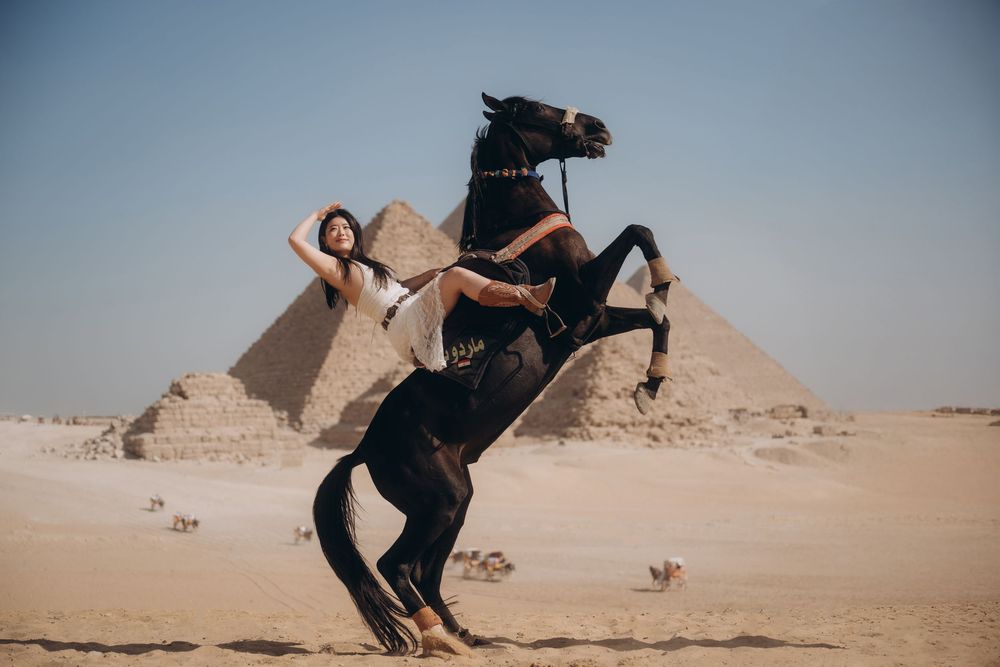 A sequence of photos showing someone jumping and doing acrobatic poses in front of the Egyptian pyramids.