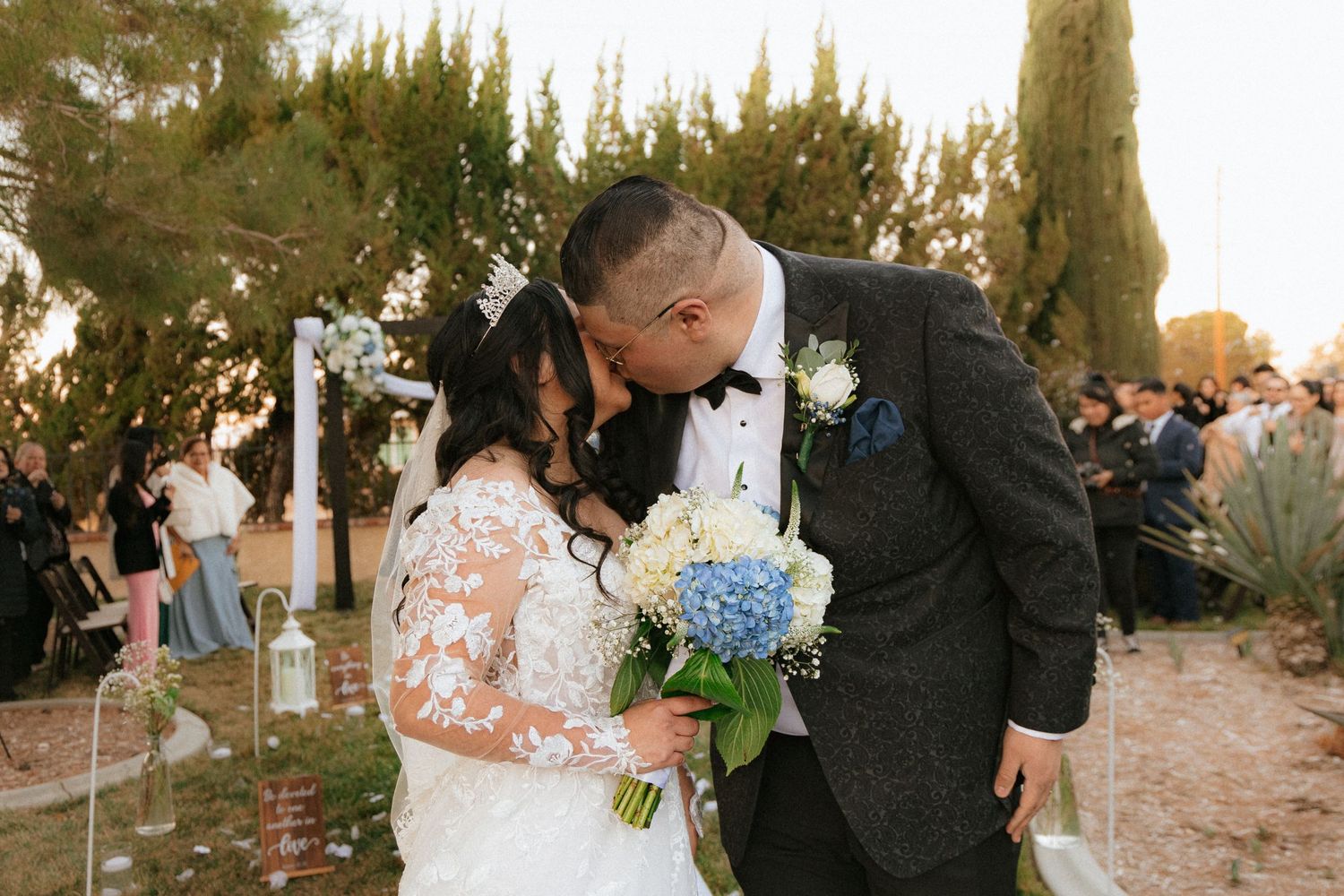 Bride and groom share intimate moments during their romantic golden hour wedding photoshoot in a desert location.