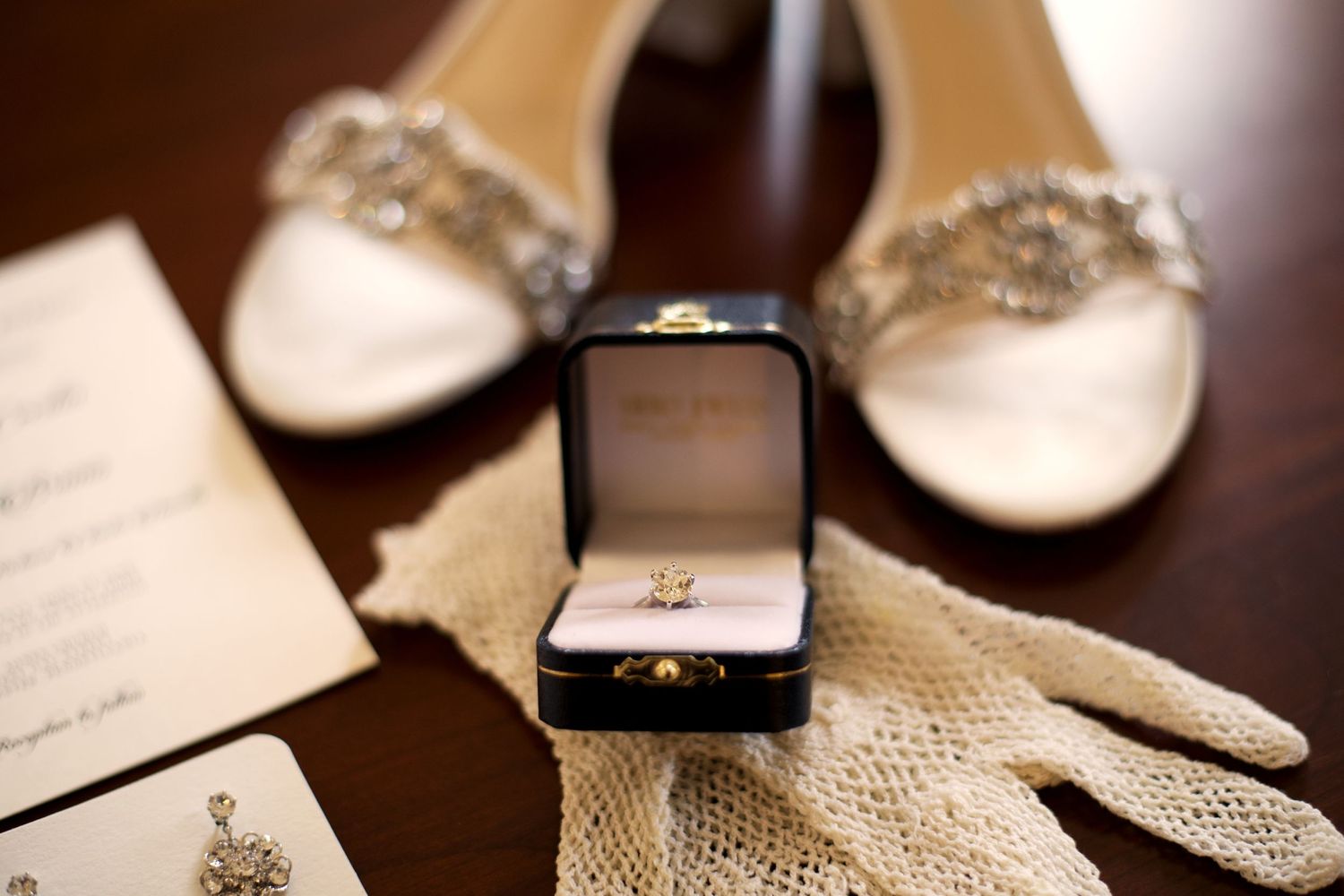 bridal flat-lay with shoes, vintage gloves, engagement ring, wedding invite, earrings, jewelry; vintage