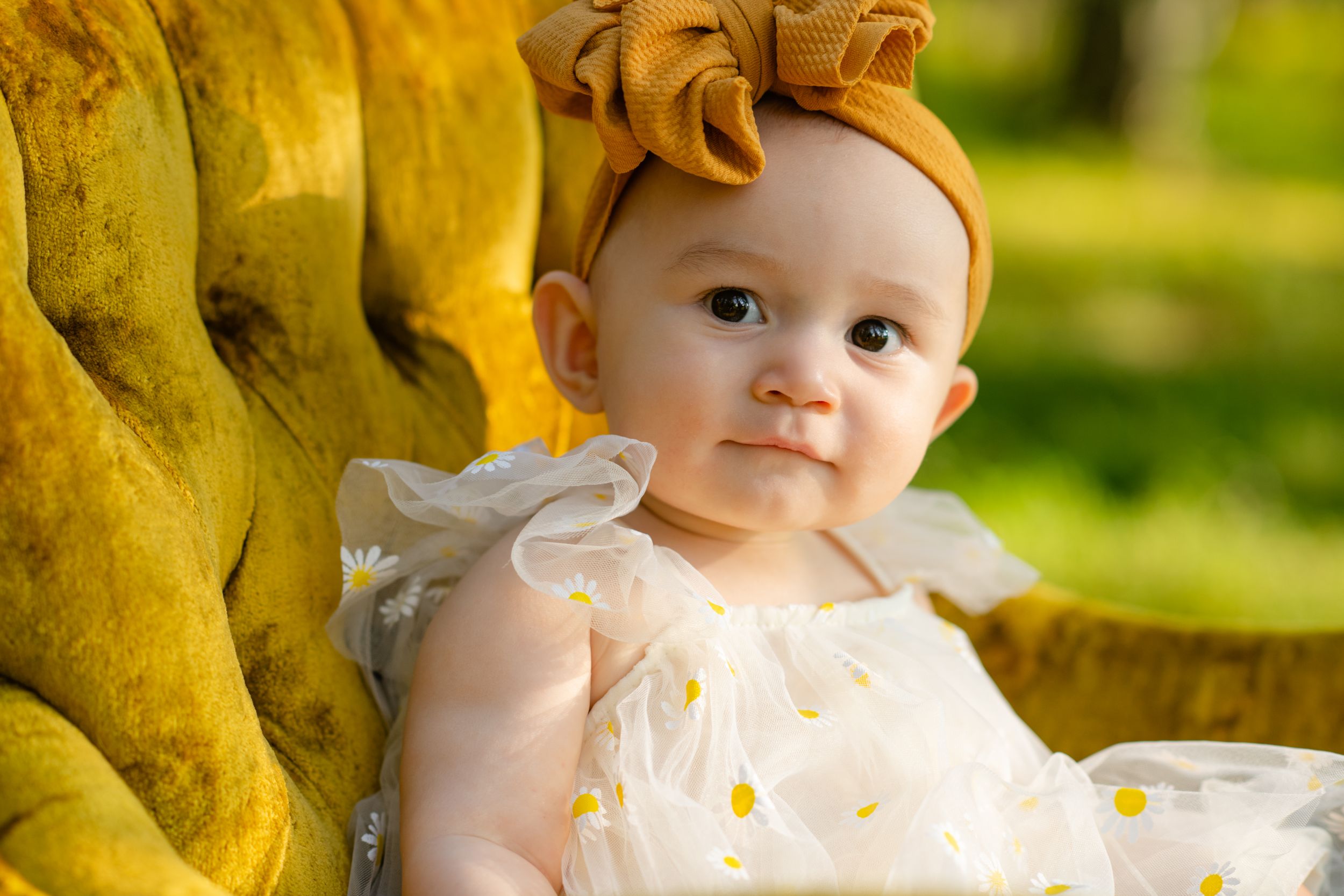 Close-up of a sleeping newborn being held while parents share an intimate moment.