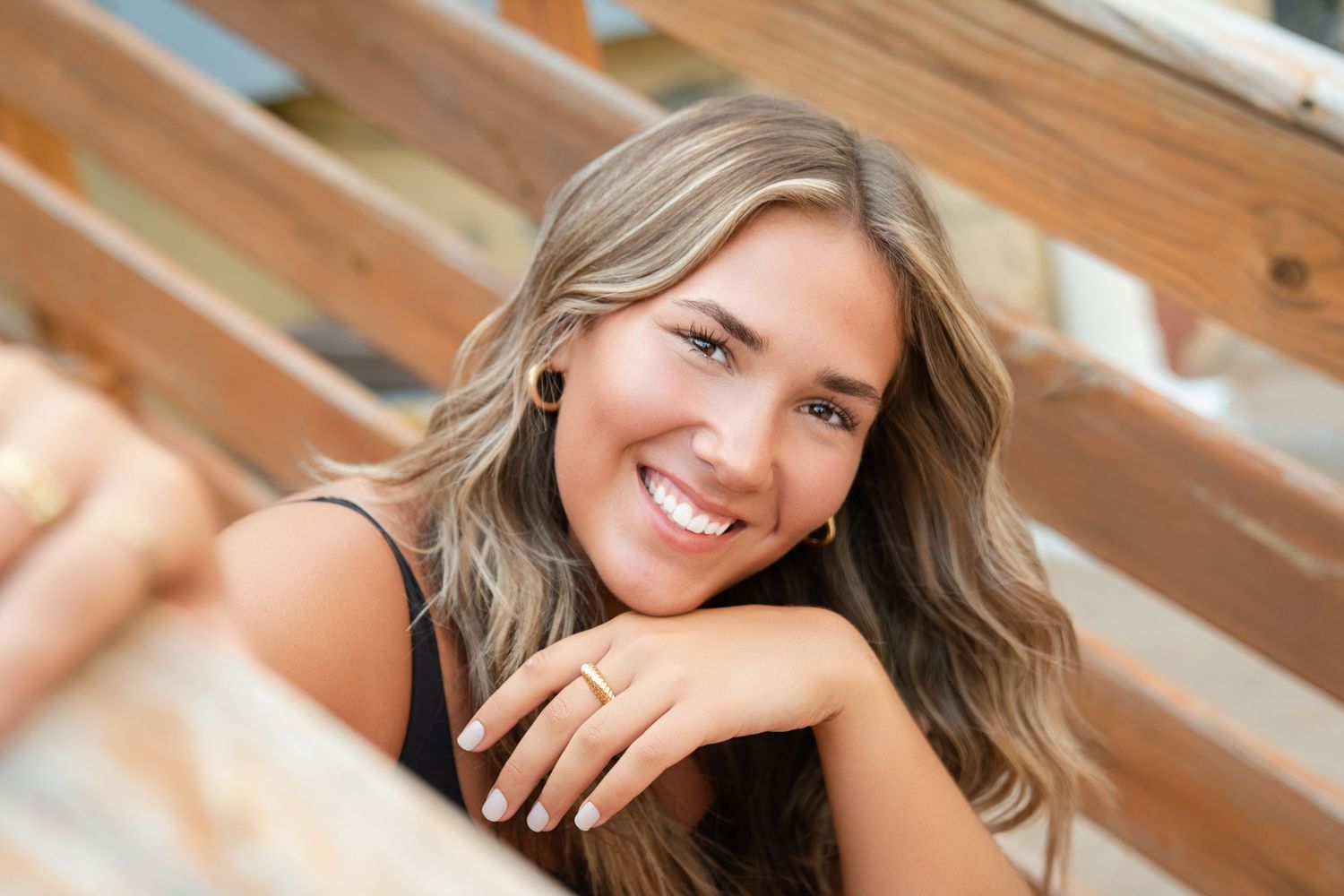 Professional portrait photo collage showing the same person in various poses with natural lighting and wooden backdrop.