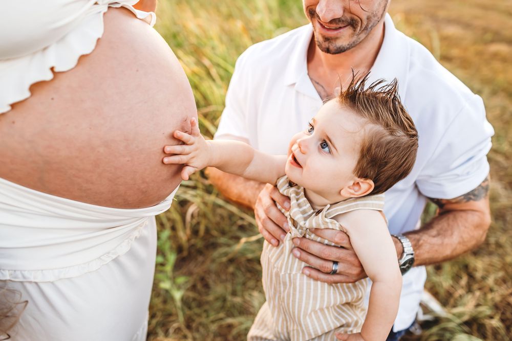 A heartwarming collection of candid family moments captured during a golden hour outdoor photoshoot in nature near Hartford, CT