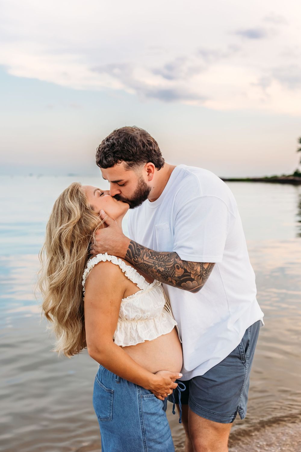 Maternity Photo Shoot with couple kissing on Northeast Beach in Guilford, Connecticut