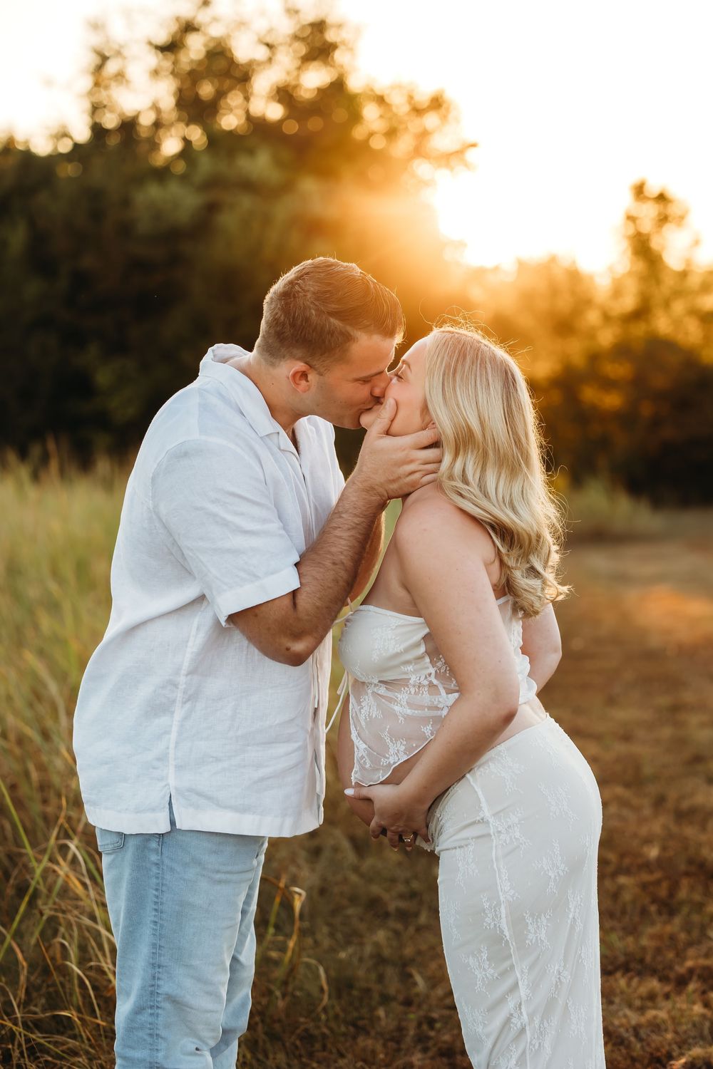 A romantic maternity photoshoot at sunset with a couple embracing in a golden field near Waterbury, CT and Yale